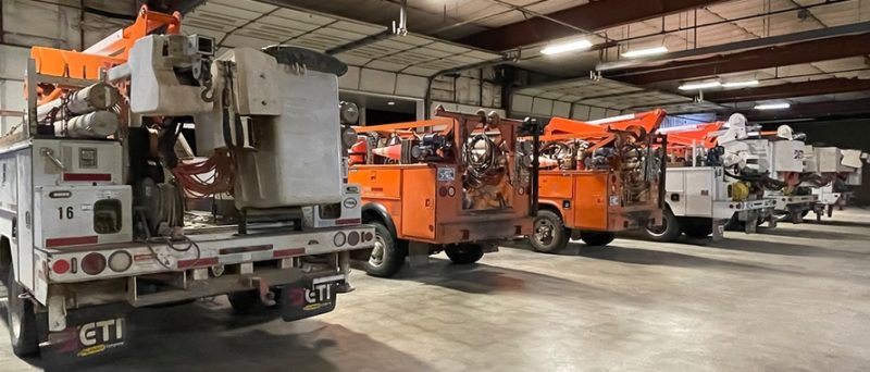 rows of orange linemen trucks