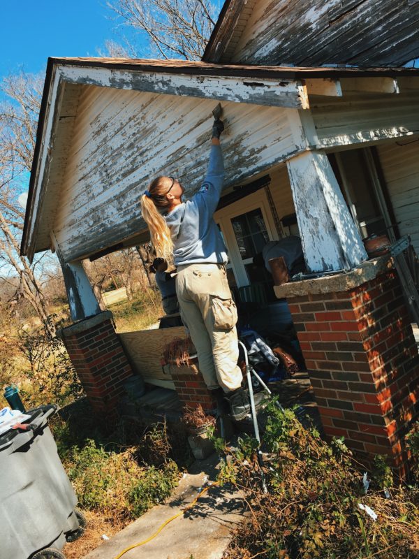 Volunteer works on damaged house