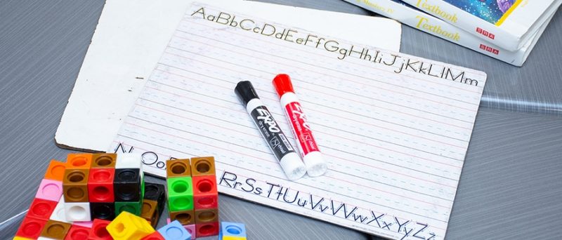 markers on student paper with lego blocks nearby