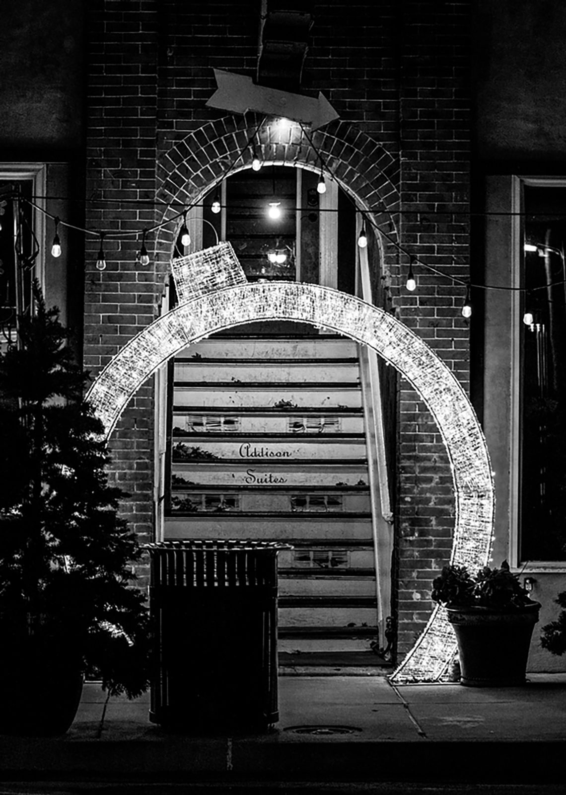 lit up ornament shaped archway in front of stairs